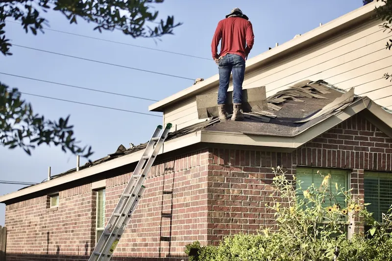 Professional roofer working on a residential roof in Wellford Estates